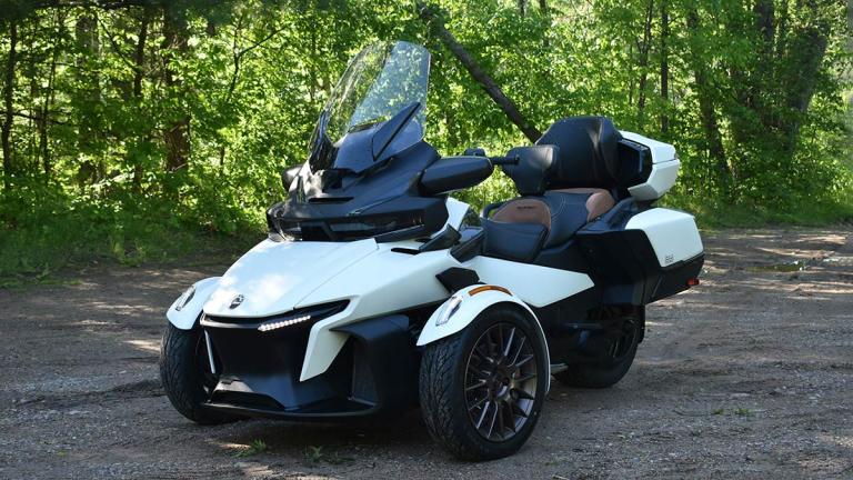 Can-Am Spyder RT parked by trees.